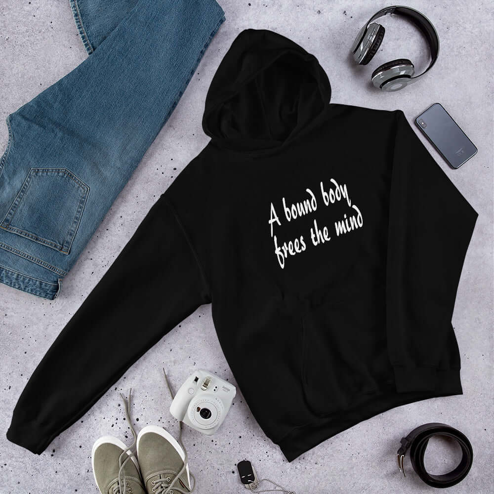 Black hoodie sweatshirt with the BDSM phrase A bound body frees the mind printed on the front.