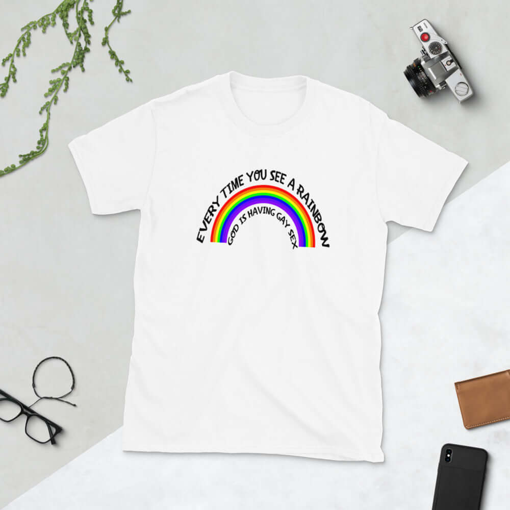 White t-shirt with a rainbow graphic & the phrase Every time you see a rainbow God is having gay sex printed on the front.