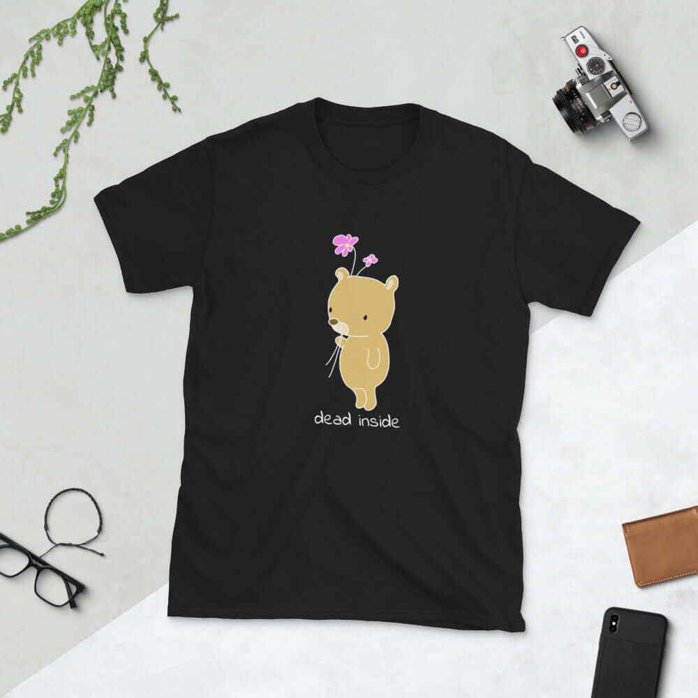 Black t-shirt with an image of a cute bear holding 2 pink flowers. The words Dead inside are printed underneath the bear. The graphics are printed on the front of the shirt.