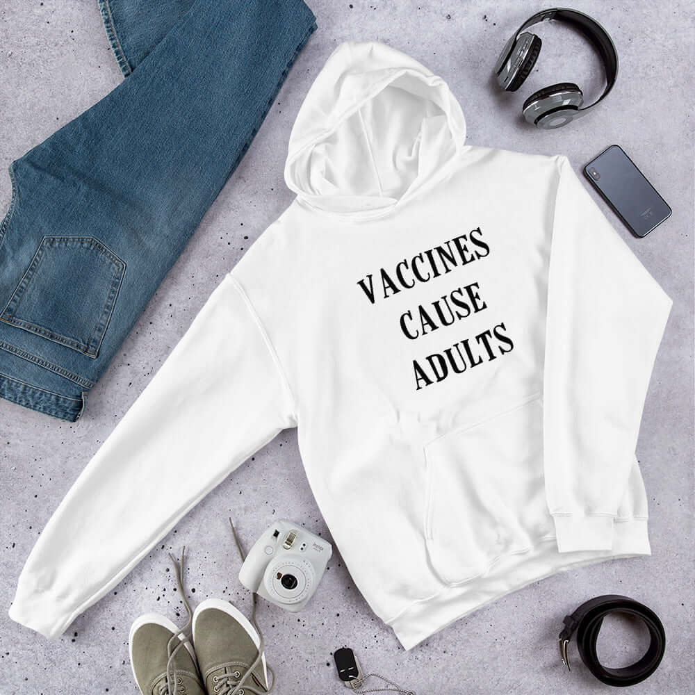 White hoodie sweatshirt with the words Vaccines cause adults printed on the front.