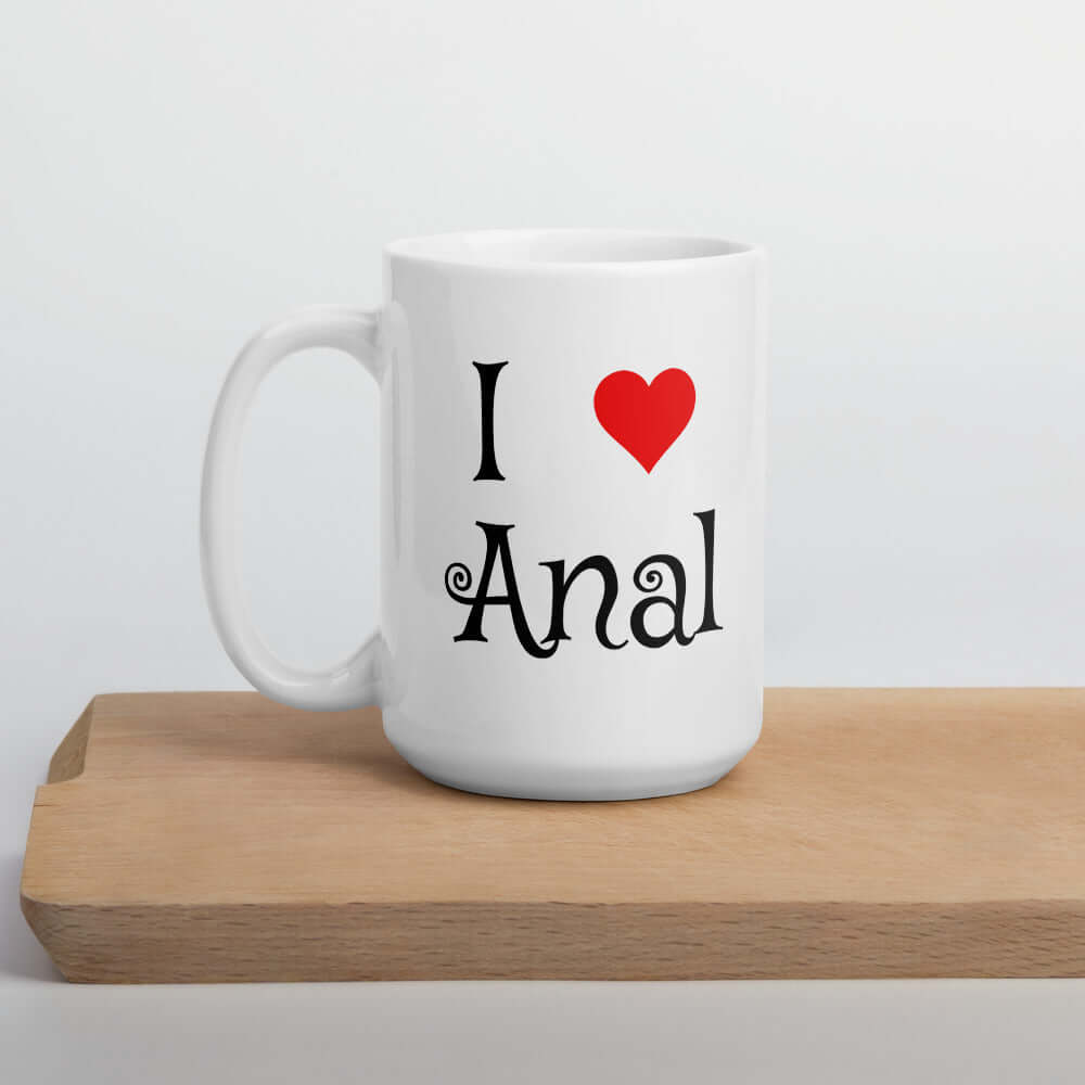 White ceramic coffee mug with the words I heart anal printed on both sides. The heart is red.