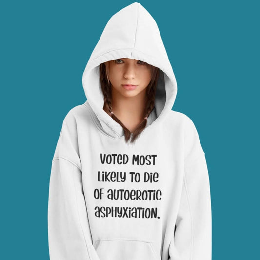 Woman wearing white hoodie sweatshirt with the hood up covering some of her face. The hoodie has the phrase Voted most likely to die of autoerotic asphyxiation printed on the front.