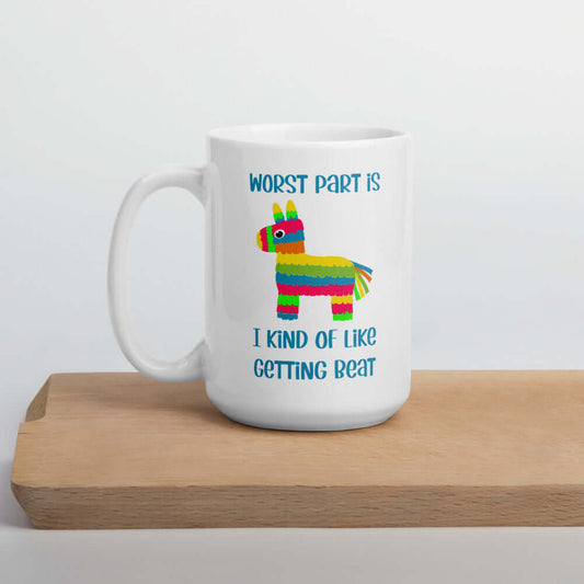 White ceramic coffee mug with an image of a colorful donkey pinata & the words Worst part is I kind of like getting beat printed on both sides.