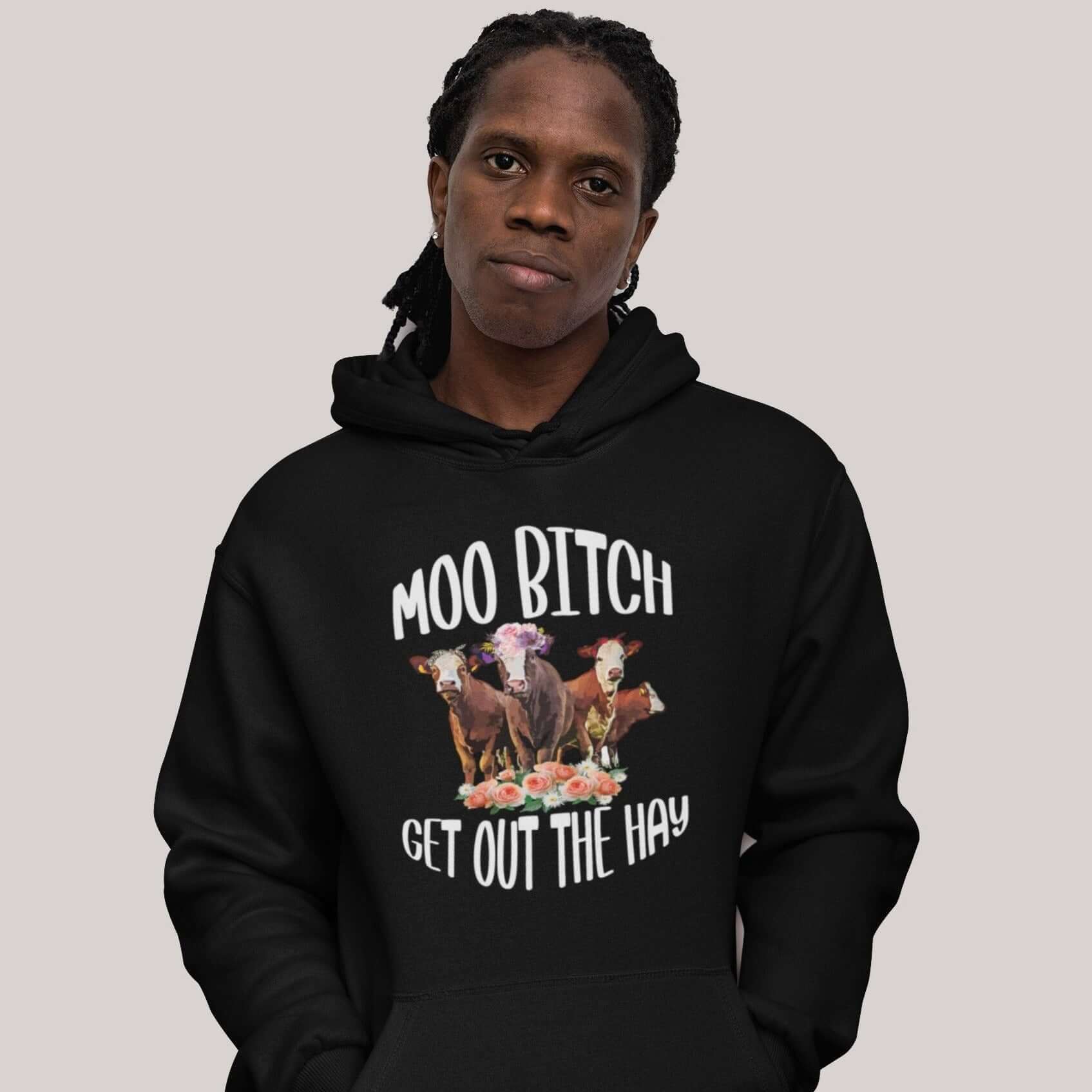 Man wearing black hoodie sweatshirt with an image of 3 cows and the words Moo bitch get out the hay printed on the front.