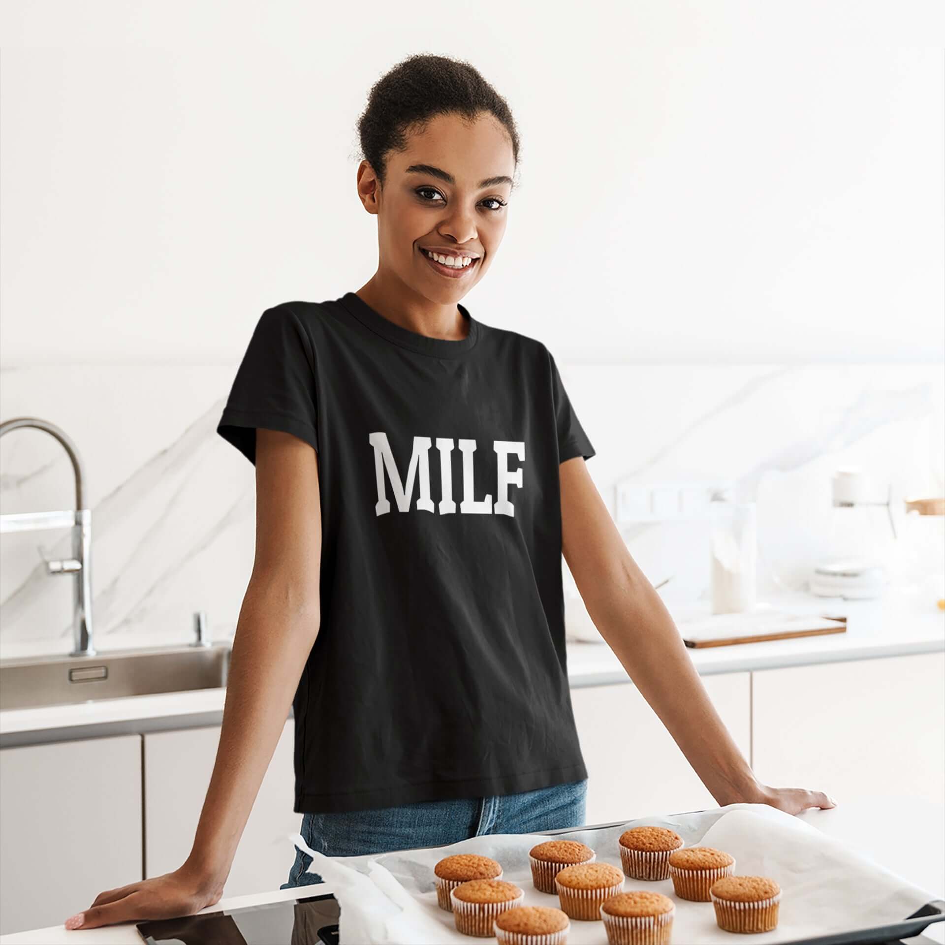 Woman wearing a black t-shirt with the acronym MILF printed on the front.