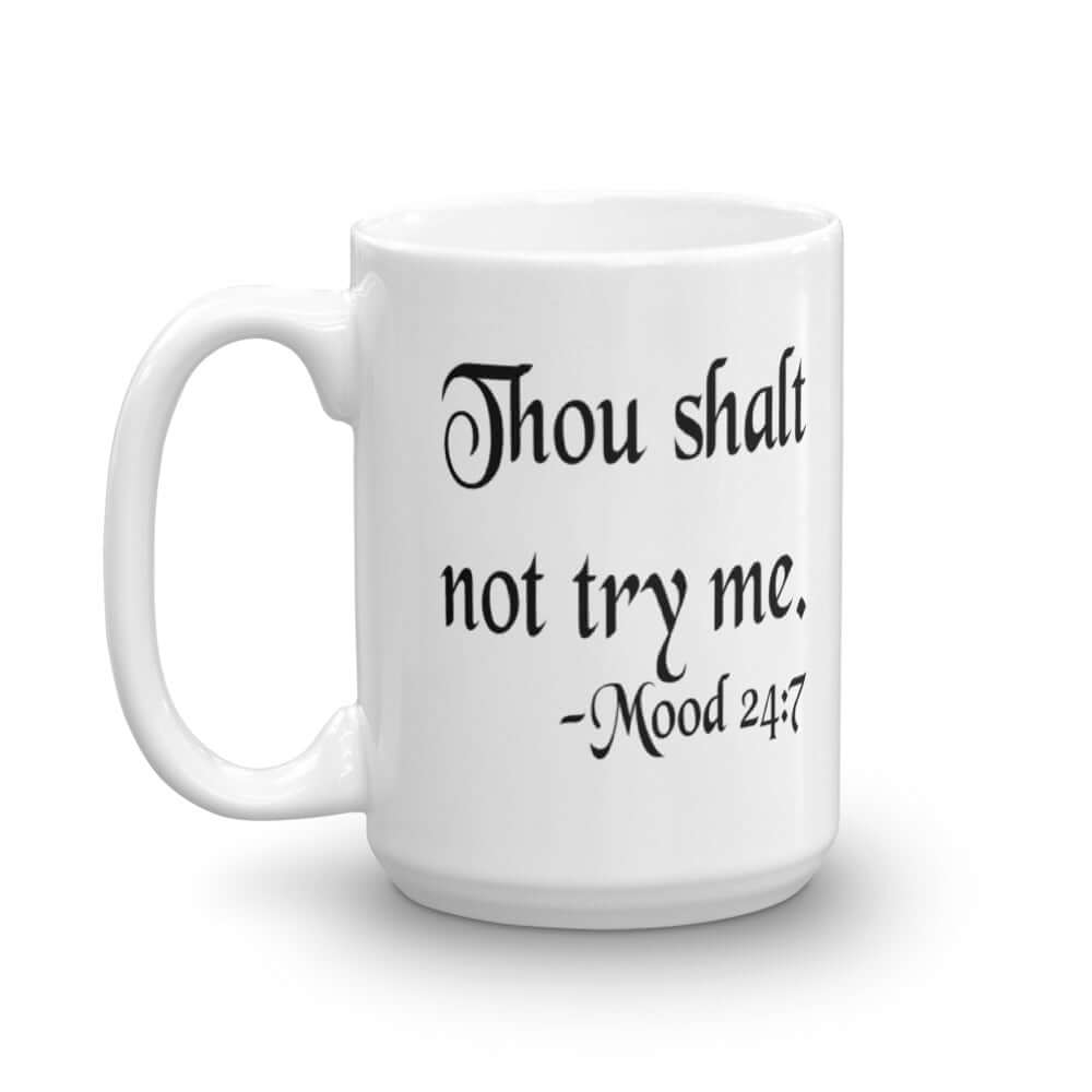 White ceramic coffee mug with the mock scripture quote Thou shalt not try me Mood 24:7 printed on both sides of the mug.