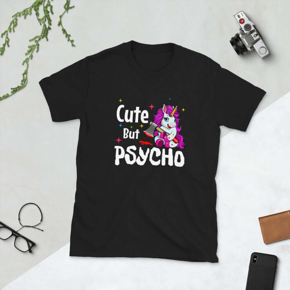 Black t-shirt that has a graphic of a unicorn holding a knife & the words Cute but psycho printed on the front.