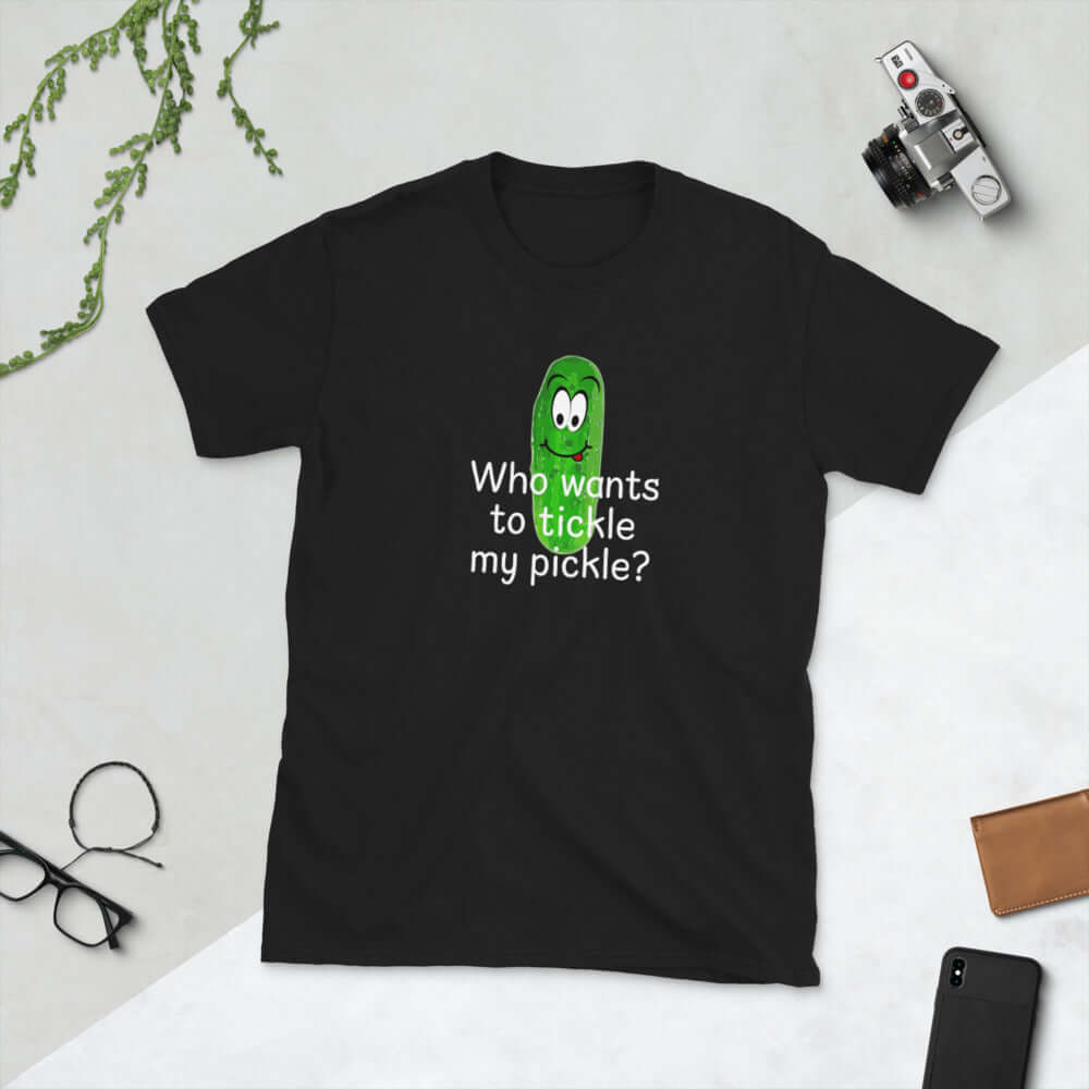 Black t-shirt with an image of a pickle printed on the front. The words Who wants to tickle my pickle are printed under the pickle.