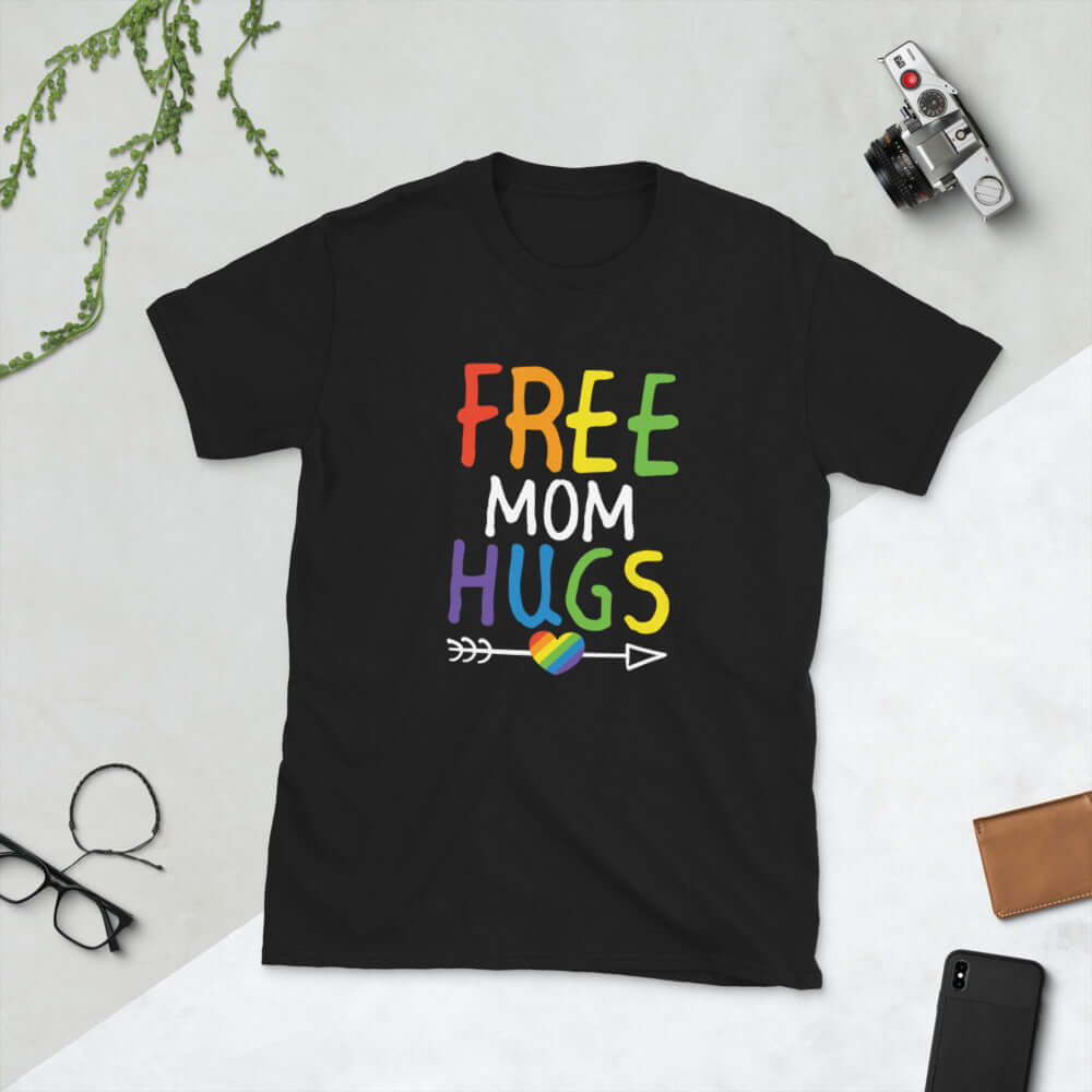 Black t-shirt with the words Free Mom hugs in rainbow lettering printed on the front.