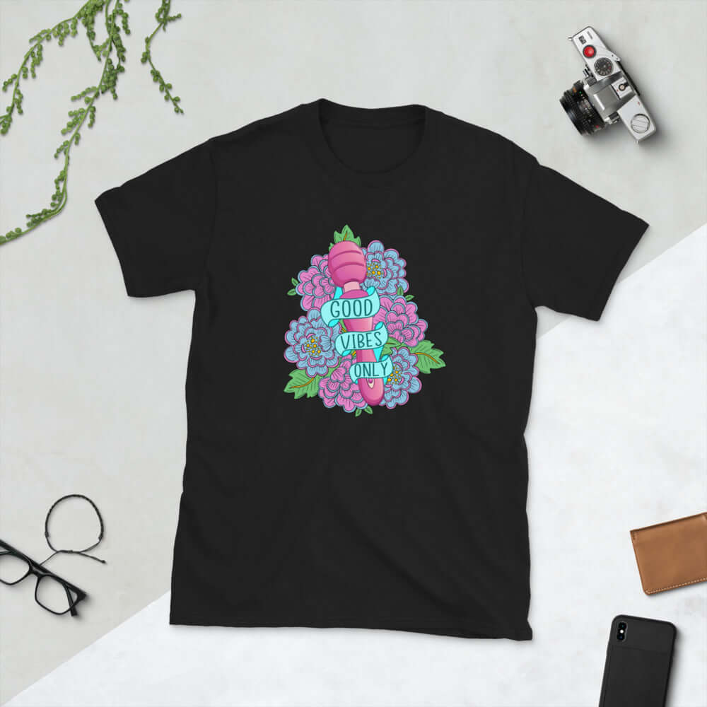 Black t-shirt with graphic design that has the words Good vibes only layered over a pink wand vibrator with flowers around. The graphic design is printed on the front of the shirt.