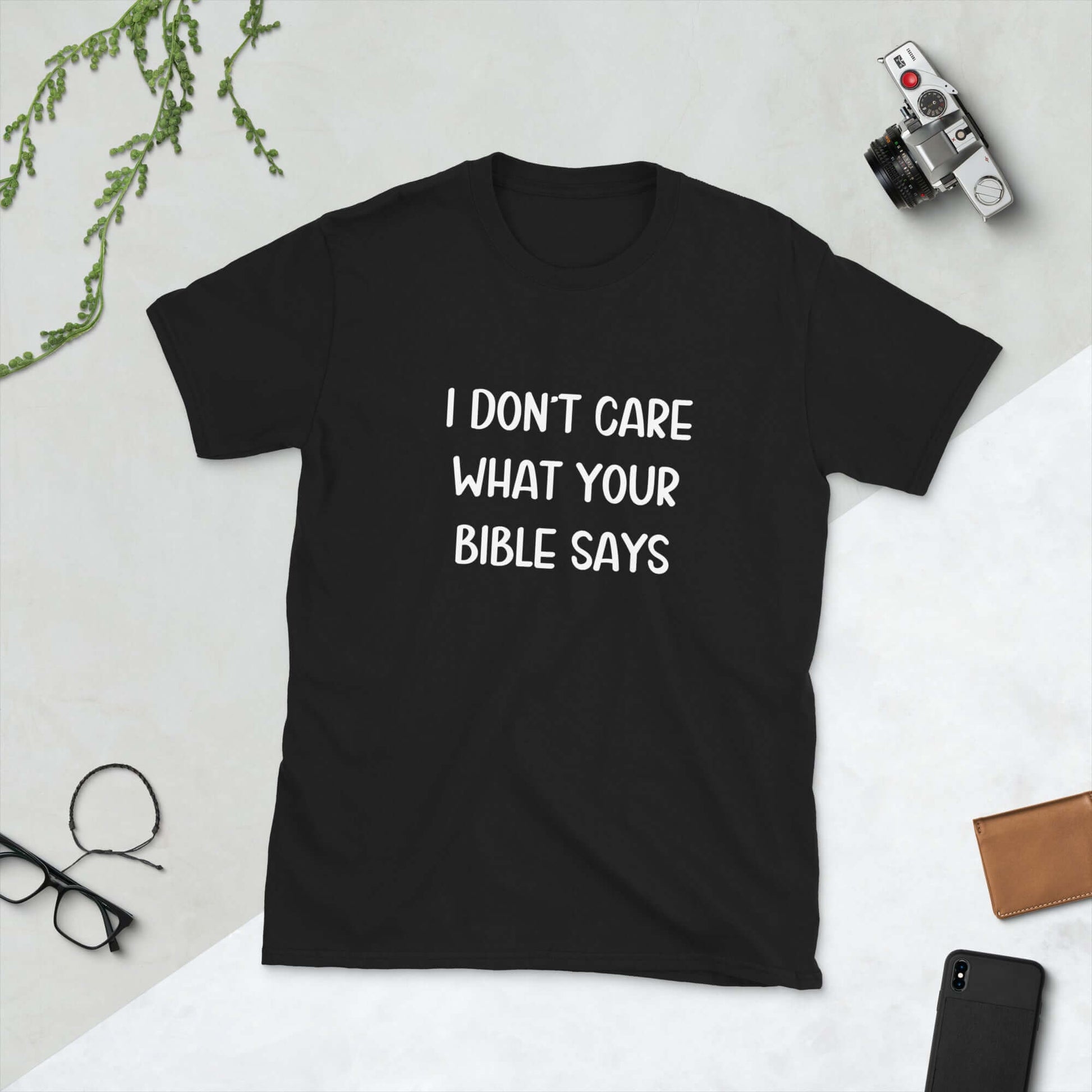 Black t-shirt with the words I don't care what your bible says printed on the front.