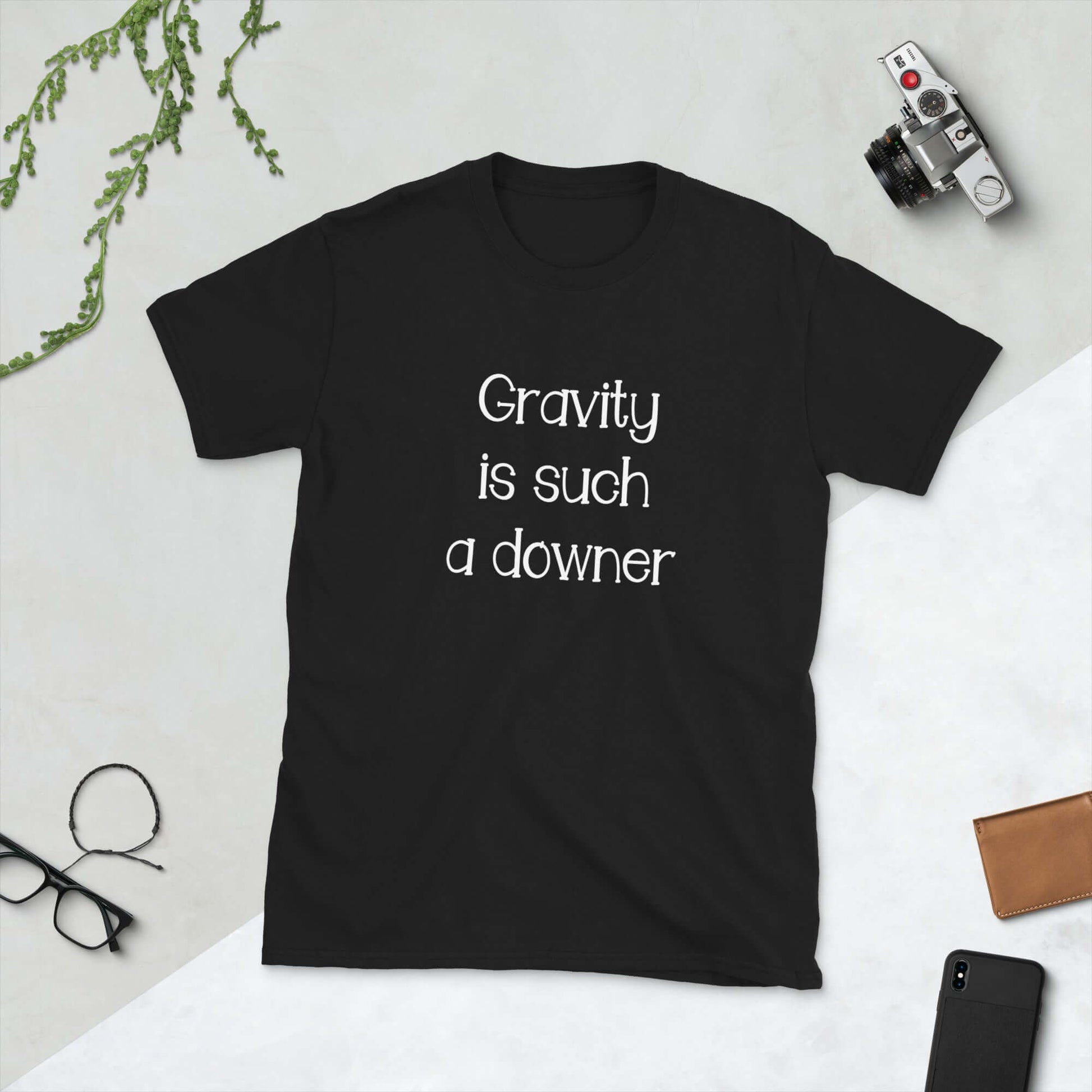 Black t-shirt with the words Gravity is such a downer printed on the front.