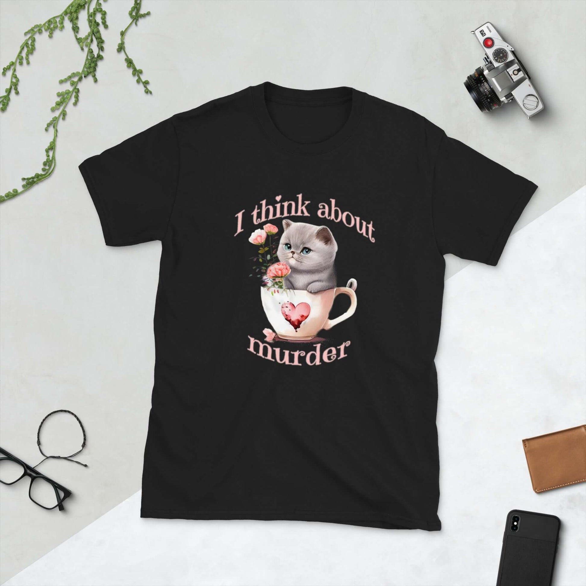 Black t-shirt that says I think about murder with image of cute fluffy kitten sitting in a teacup printed on the front.