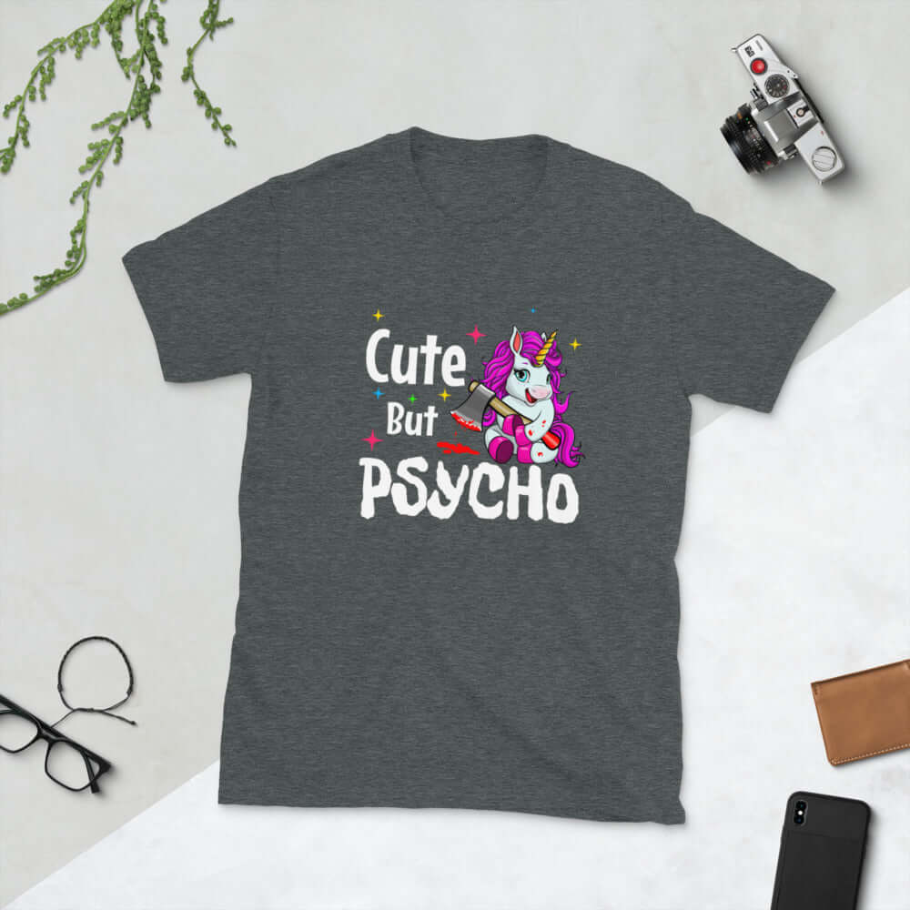 Dark heather grey t-shirt that has a graphic of a unicorn holding a knife & the words Cute but psycho printed on the front.