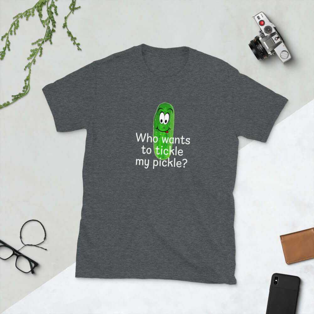 Dark heather grey t-shirt with an image of a pickle printed on the front. The words Who wants to tickle my pickle are printed under the pickle.