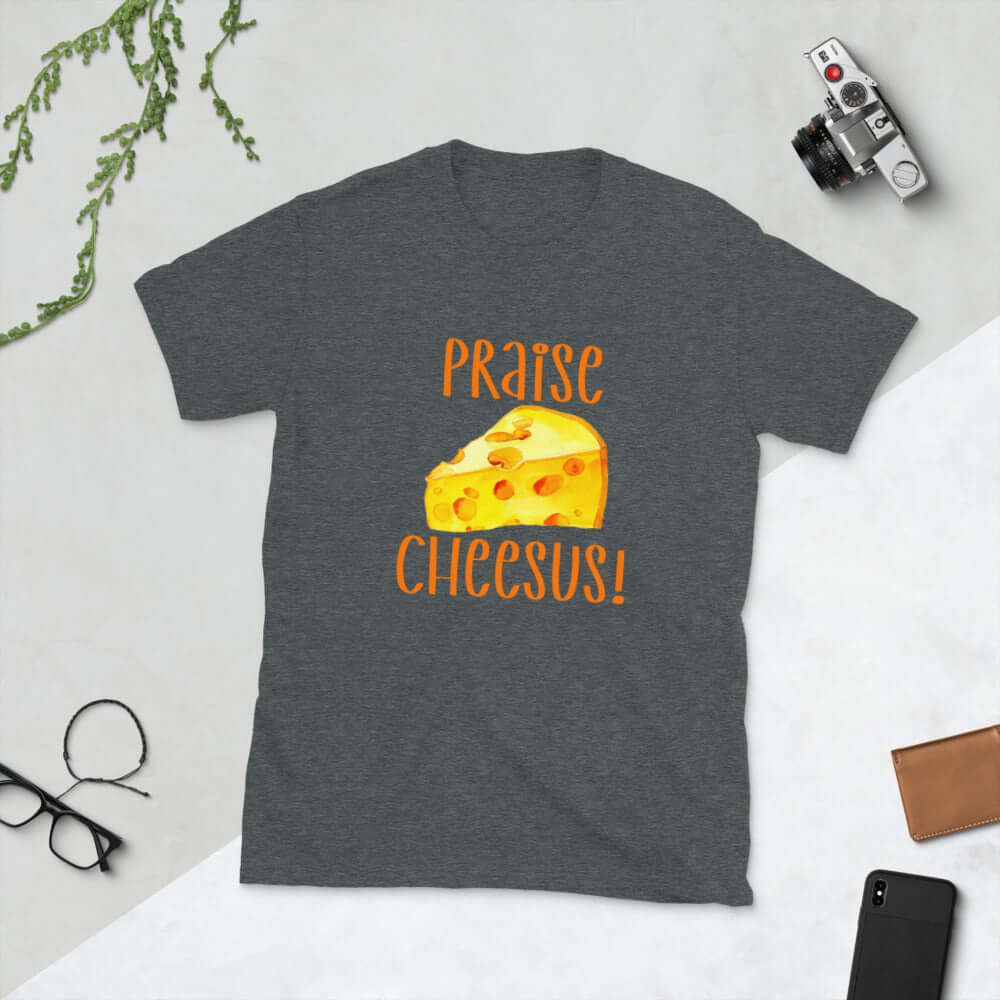 Dark heather grey t-shirt with funny graphics of a piece of swiss cheese and the words Praise Cheesus printed on the front of the hoodie in yellow and orange.