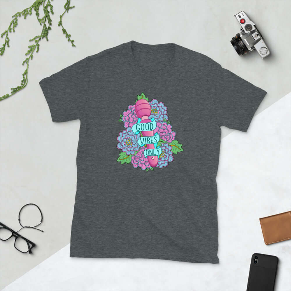 Dark grey t-shirt with graphic design that has the words Good vibes only layered over a pink wand vibrator with flowers around. The graphic design is printed on the front of the shirt.