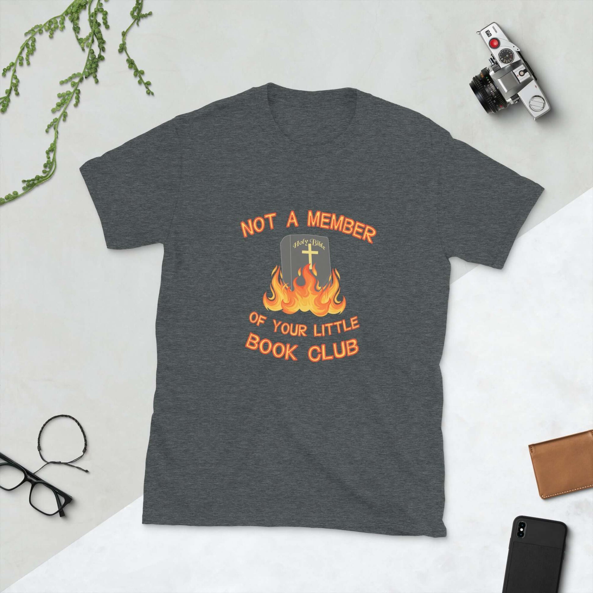 Dark heather grey t-shirt with image of a burning bible and the words Not a member of your little book club printed on the front.