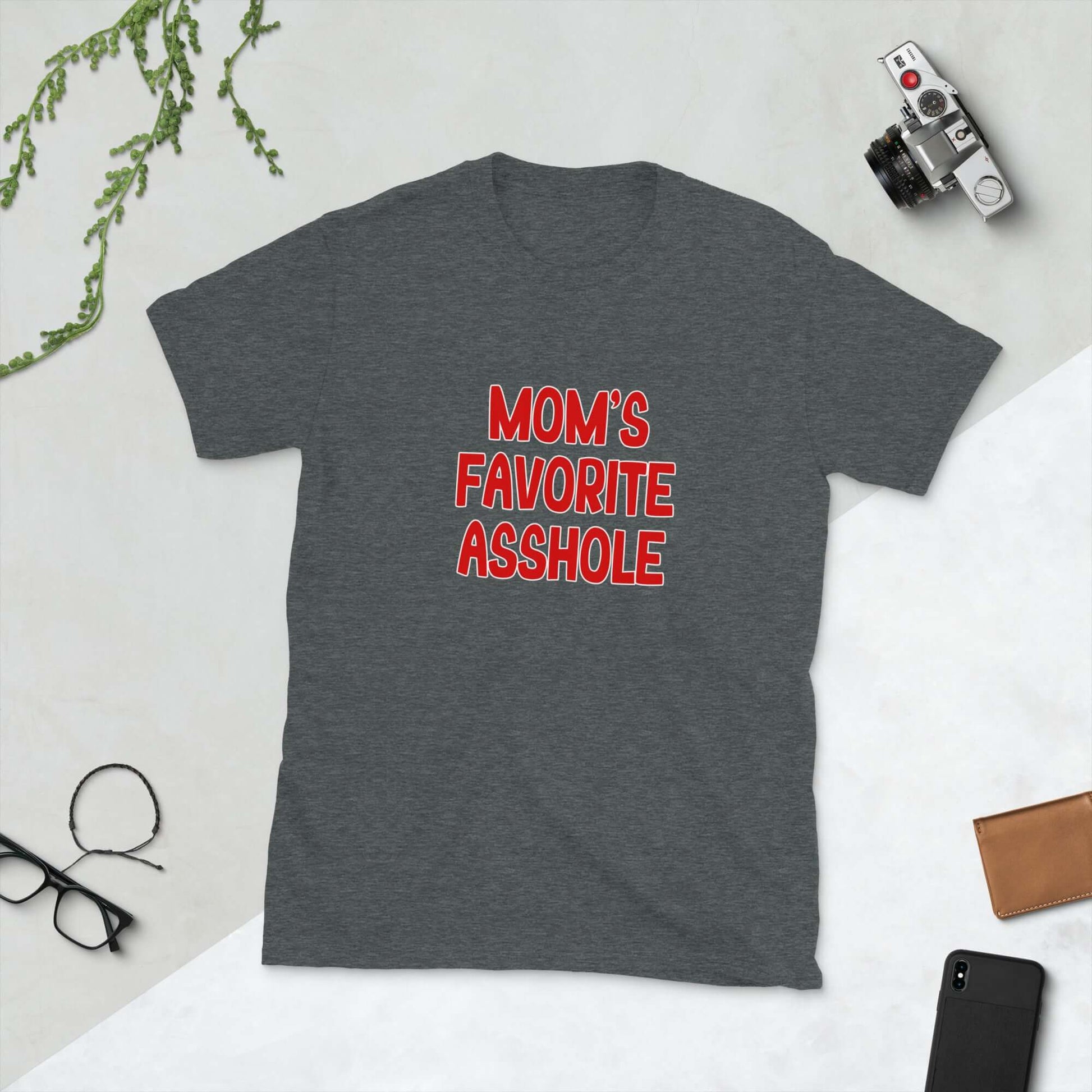 Dark grey t-shirt with the words Mom's favorite asshole printed in red on the front. 