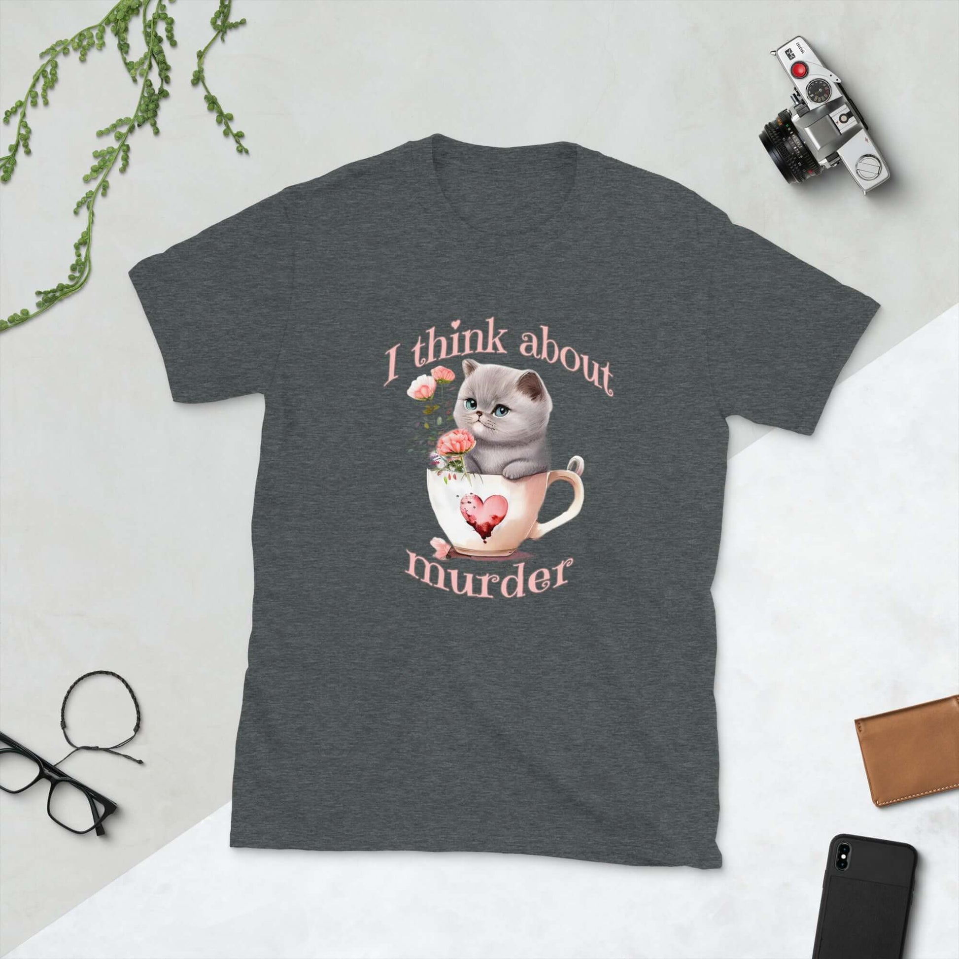 Dark grey t-shirt that says I think about murder with image of cute fluffy kitten sitting in a teacup printed on the front.