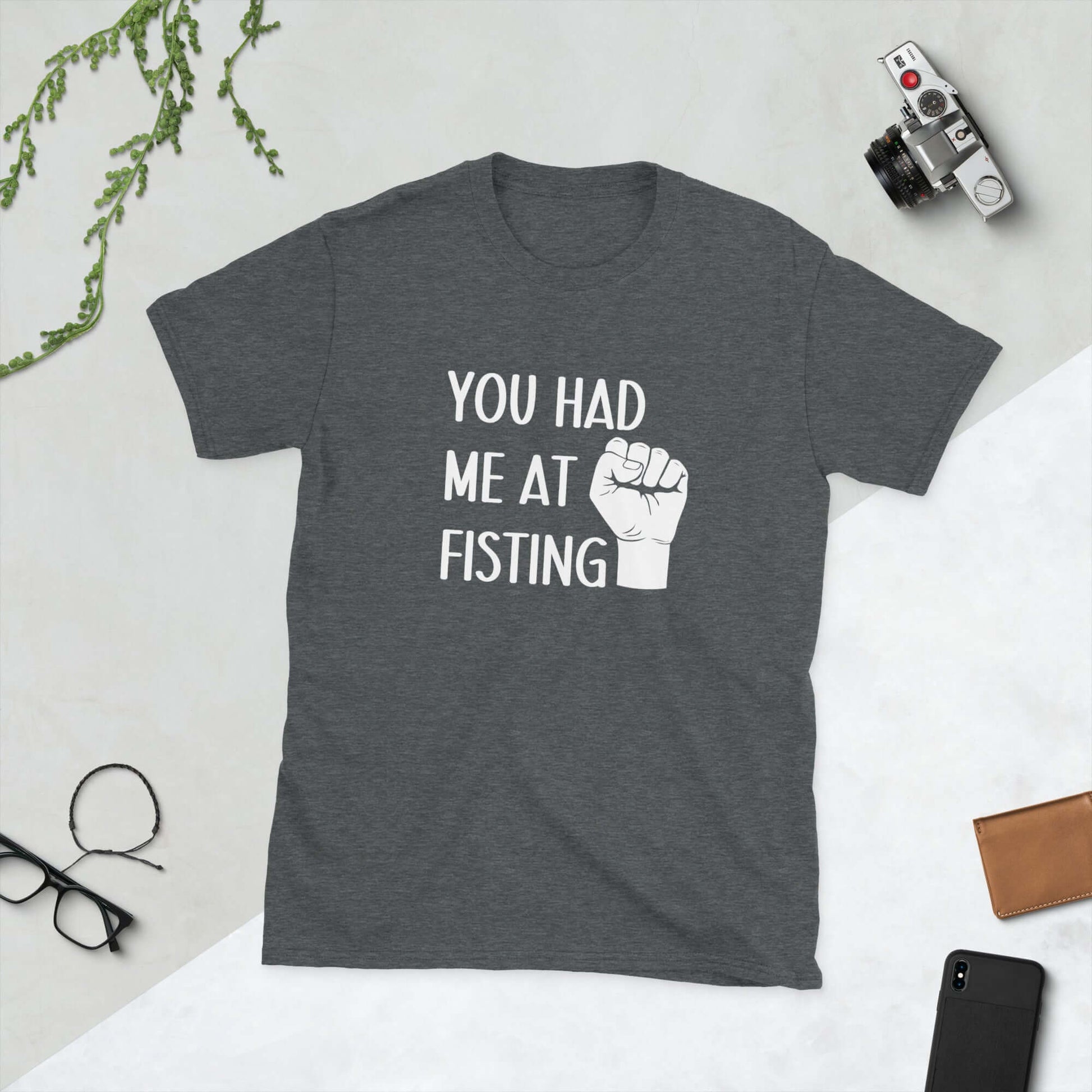 Dark grey t-shirt with image of a fist and the words You had me at fisting printed on the front.