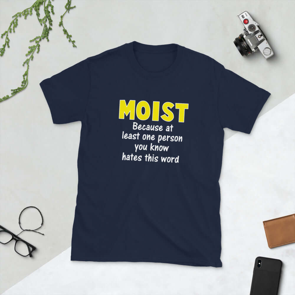 Navy blue t-shirt with the word Moist printed in large yellow bold font. In smaller font under the word moist is the phrase Because at least one person you know hates this word. 