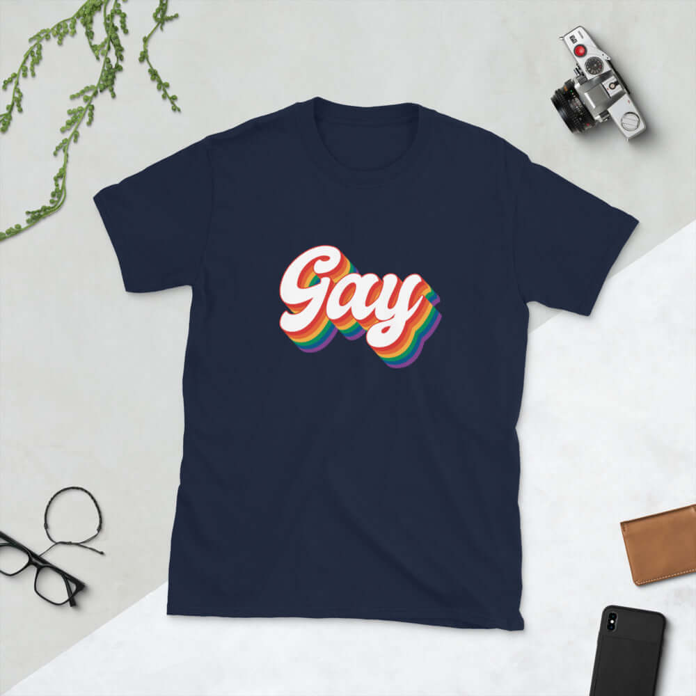 Navy blue t-shirt with the word Gay printed on the front. The word gay is outlined in rainbow.