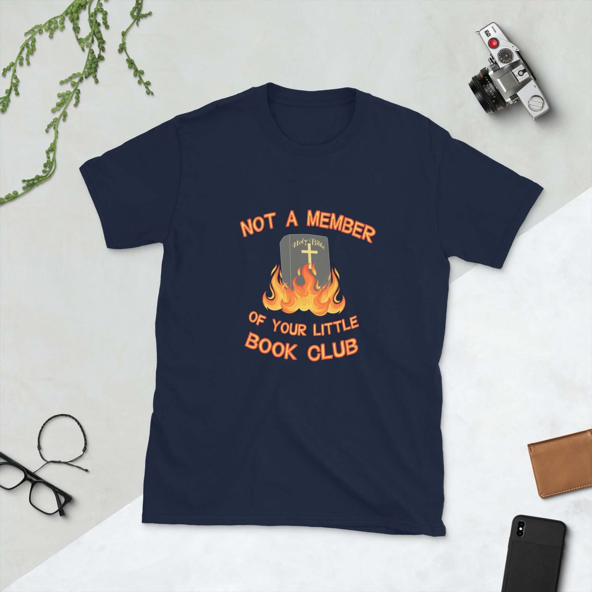 Navy blue t-shirt with image of a burning bible and the words Not a member of your little book club printed on the front.