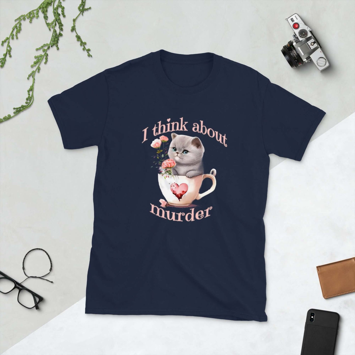 Navy blue t-shirt that says I think about murder with image of cute fluffy kitten sitting in a teacup printed on the front.