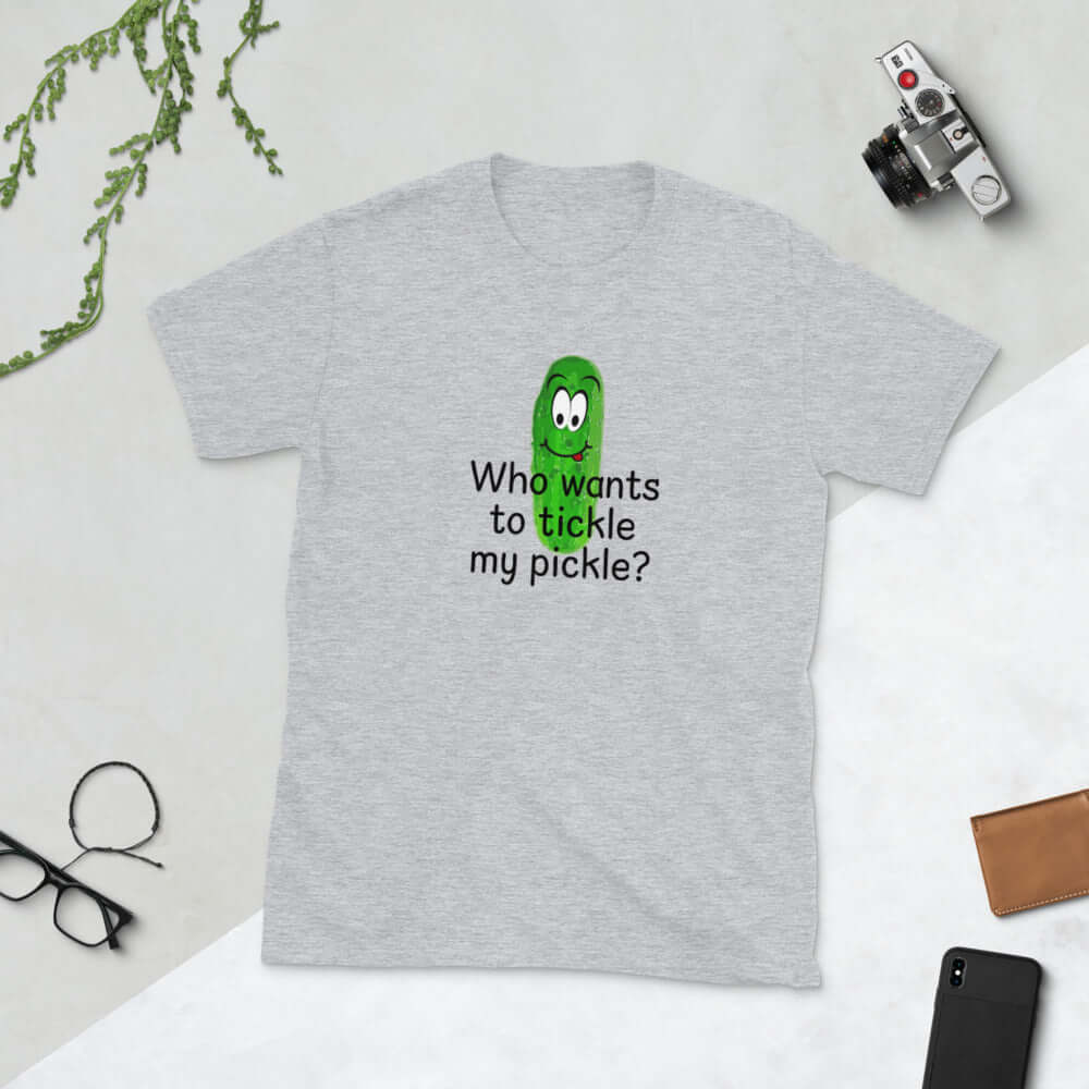 Light grey t-shirt with an image of a pickle printed on the front. The words Who wants to tickle my pickle are printed under the pickle.