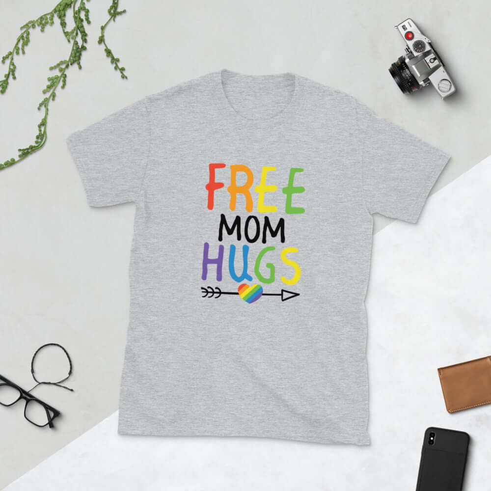 Light grey t-shirt with the words Free Mom hugs in rainbow lettering printed on the front.