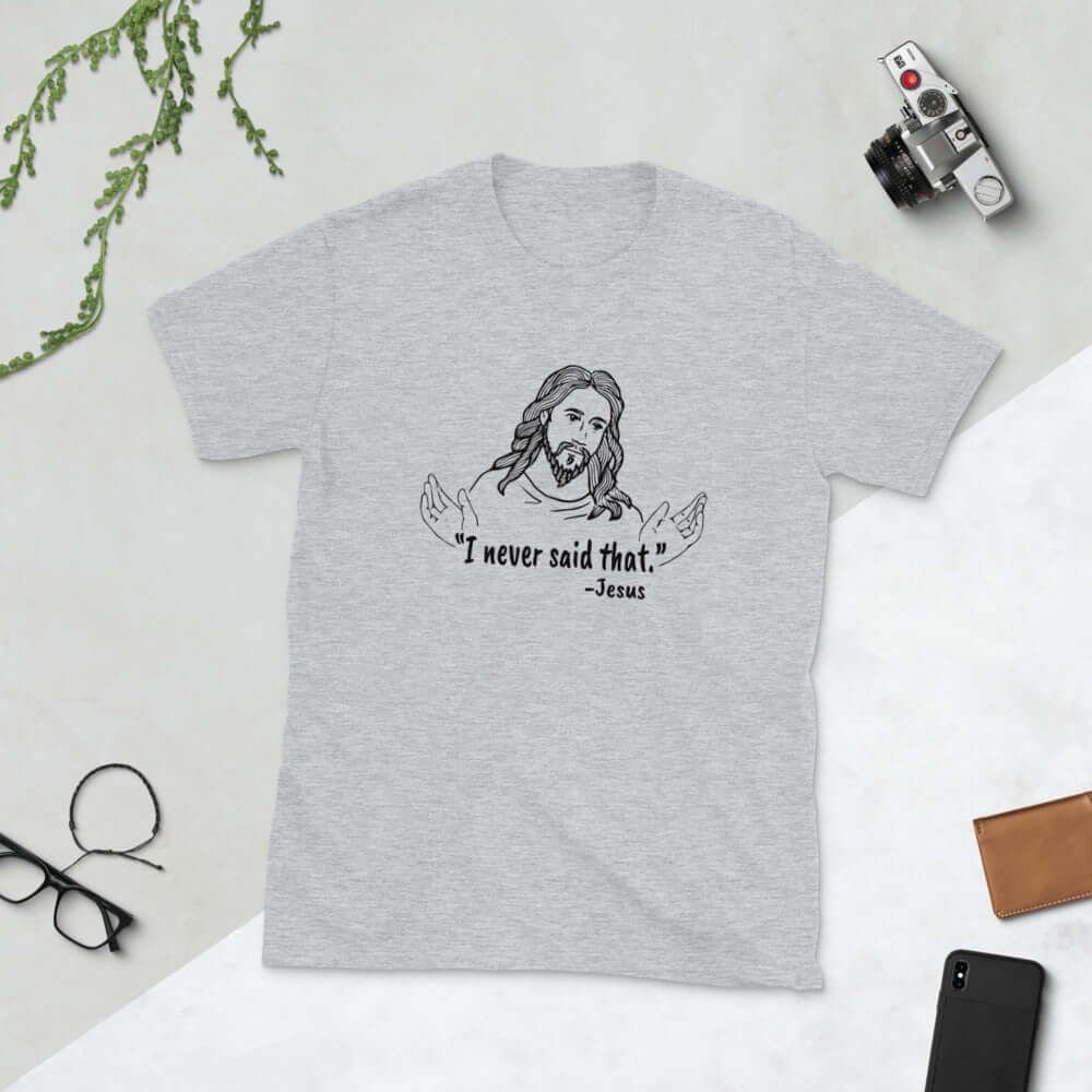 Light grey t-shirt with a line drawing of Jesus with his hands outstretched and the quote I never said that printed on the front.
