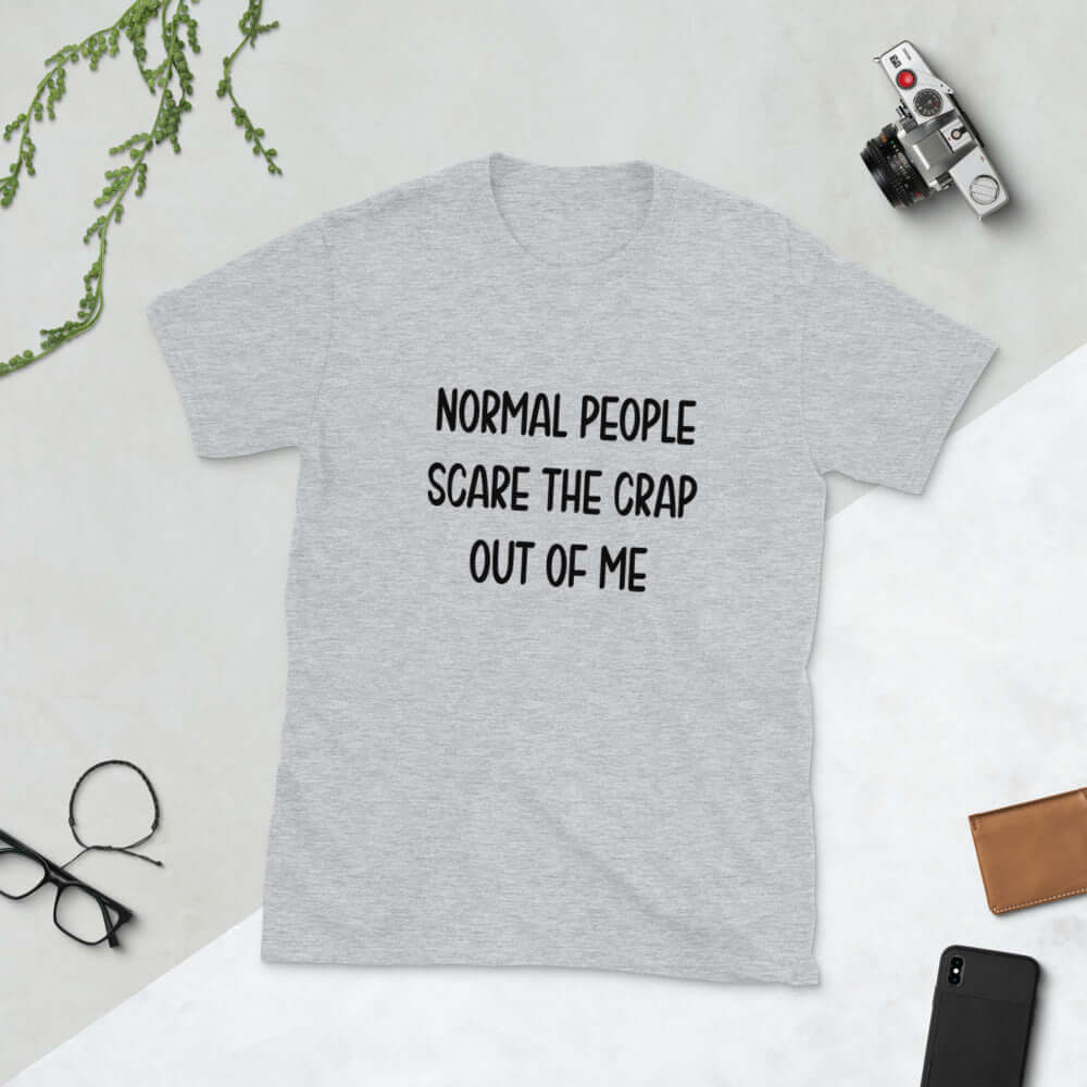 Light grey t-shirt with the phrase Normal people scare the crap out of me printed on the front.