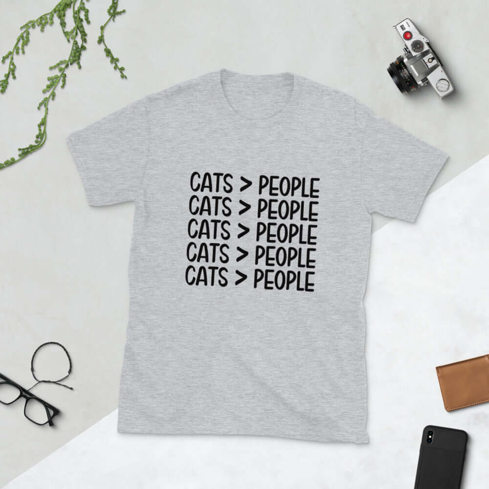 Light grey t-shirt with the words Cats > people printed on the front.