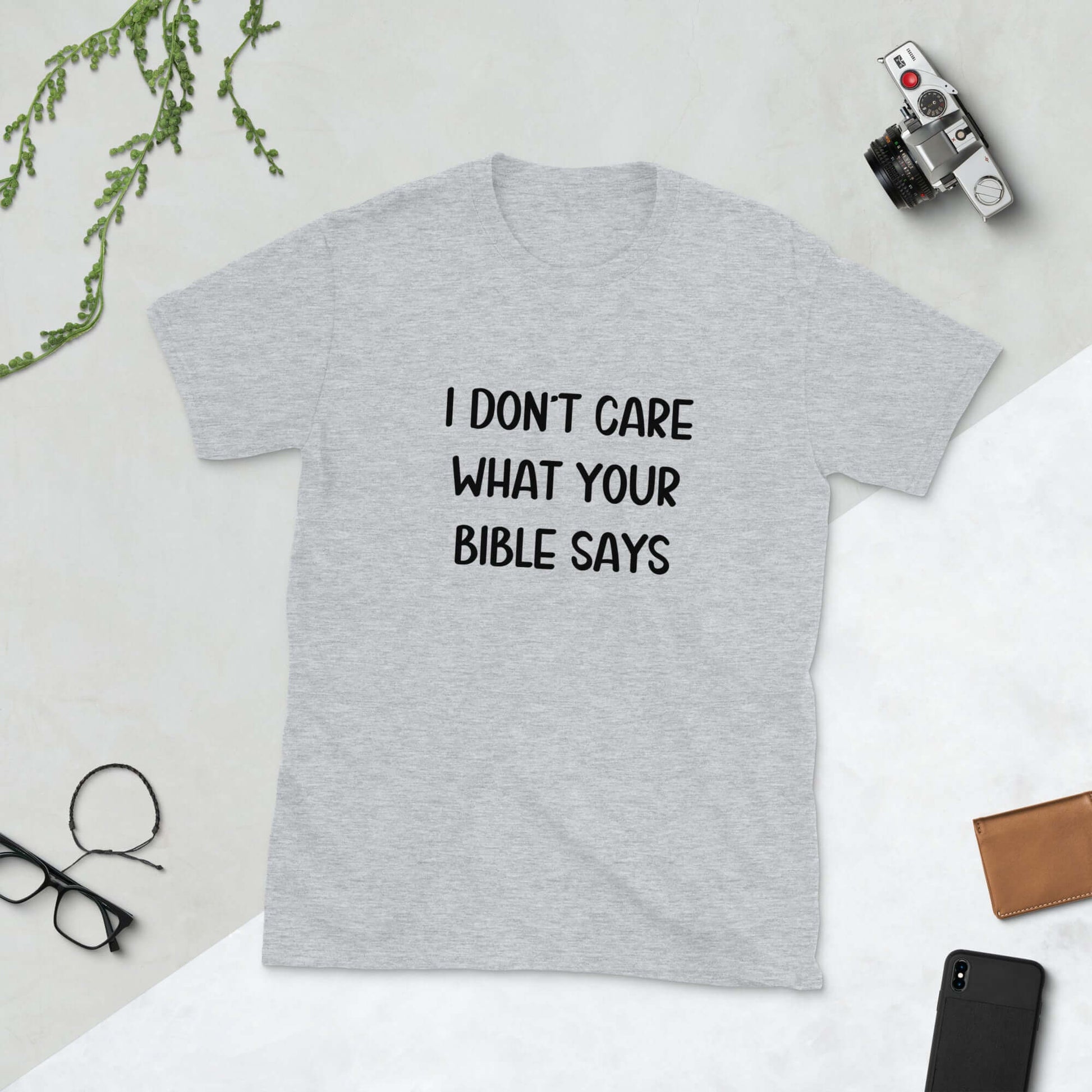 Sport grey t-shirt with the words I don't care what your bible says printed on the front.