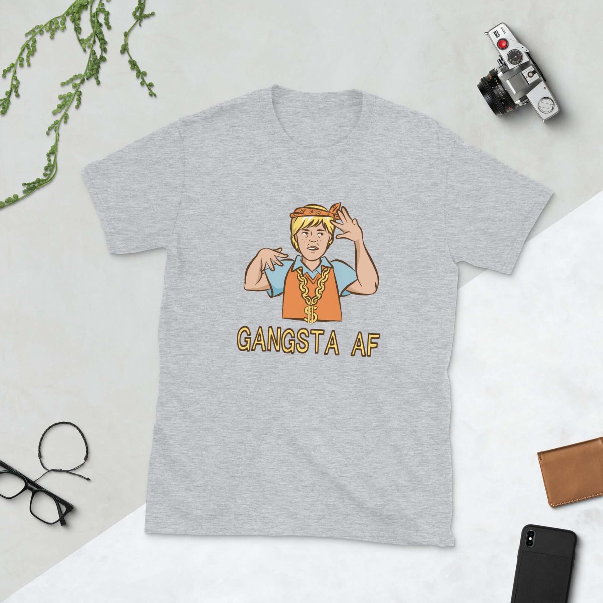 Light grey t-shirt with a parody image of a blond haired child trying to be a gangster with the words Gangsta AF printed on the front.