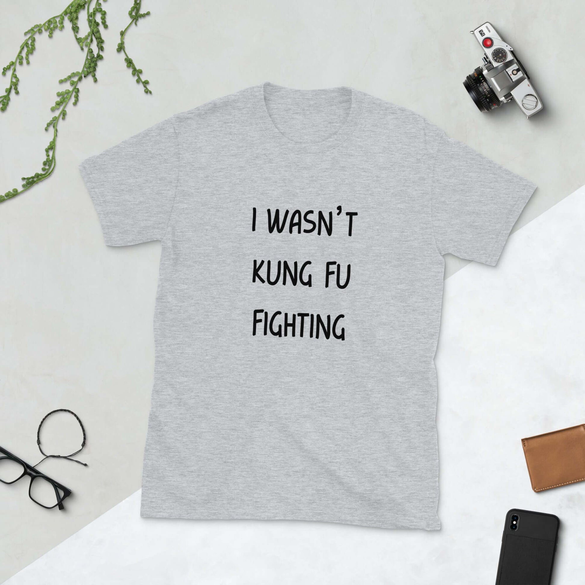 Light grey t-shirt with the funny phrase I wasn't kung fu fighting printed on the front.