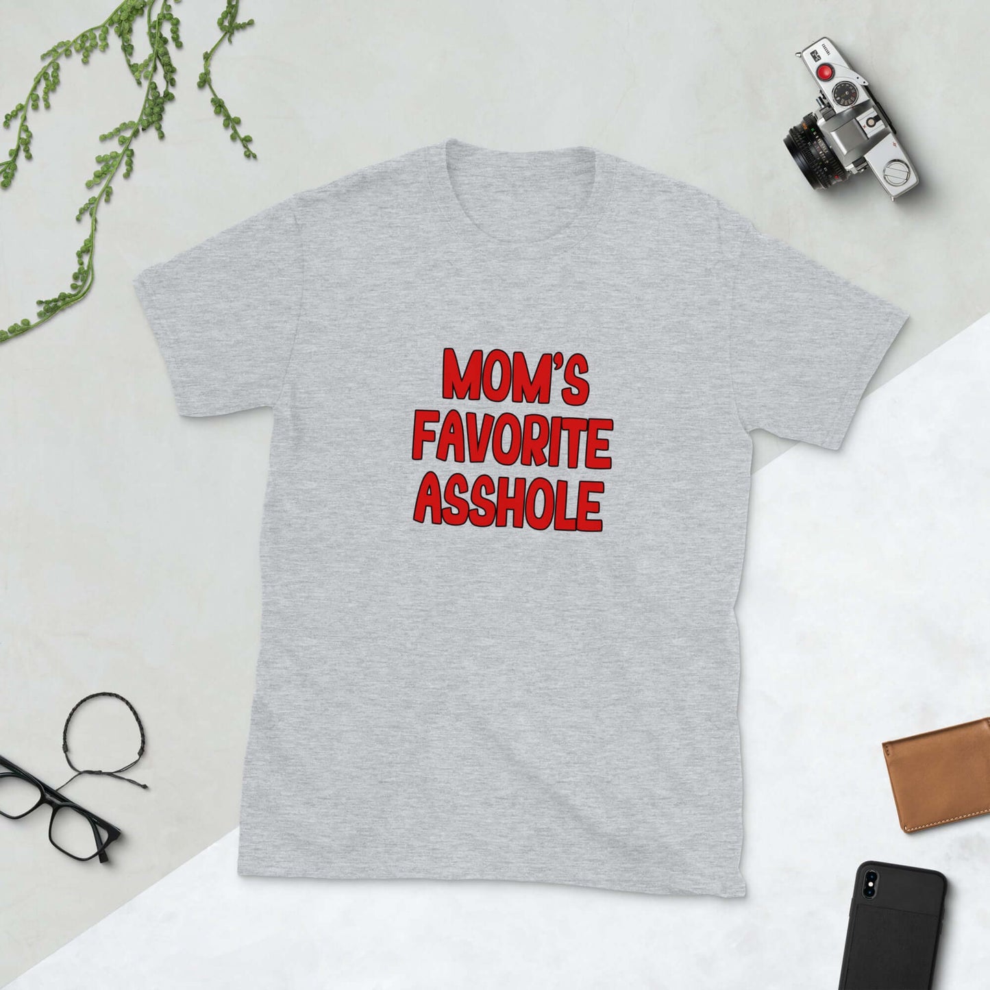 Light grey t-shirt with the words Mom's favorite asshole printed in red on the front. 