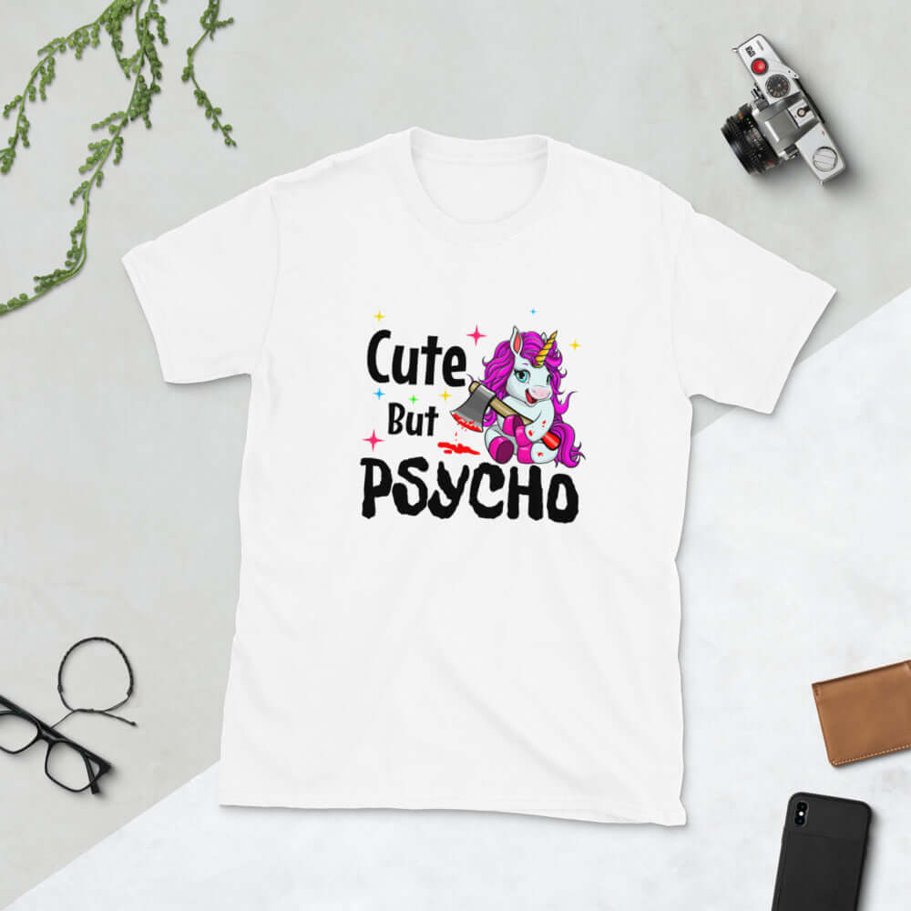 White t-shirt that has a graphic of a unicorn holding a knife & the words Cute but psycho printed on the front.