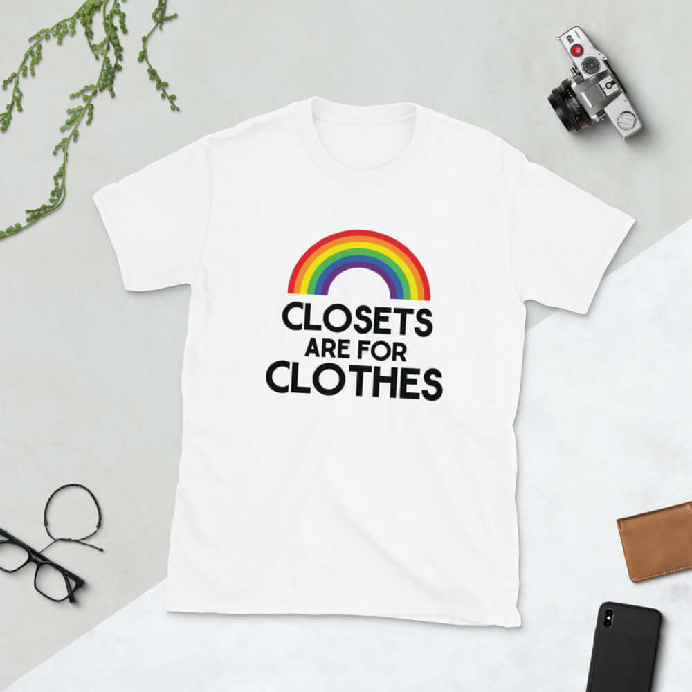 White t-shirt with a rainbow and the words Clothes are for closets printed on the front.