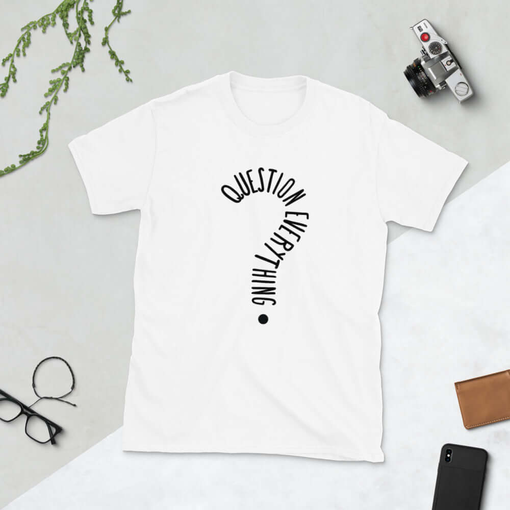 White t-shirt with the words Question everything printed on the front. The words are in the shape of a question mark.