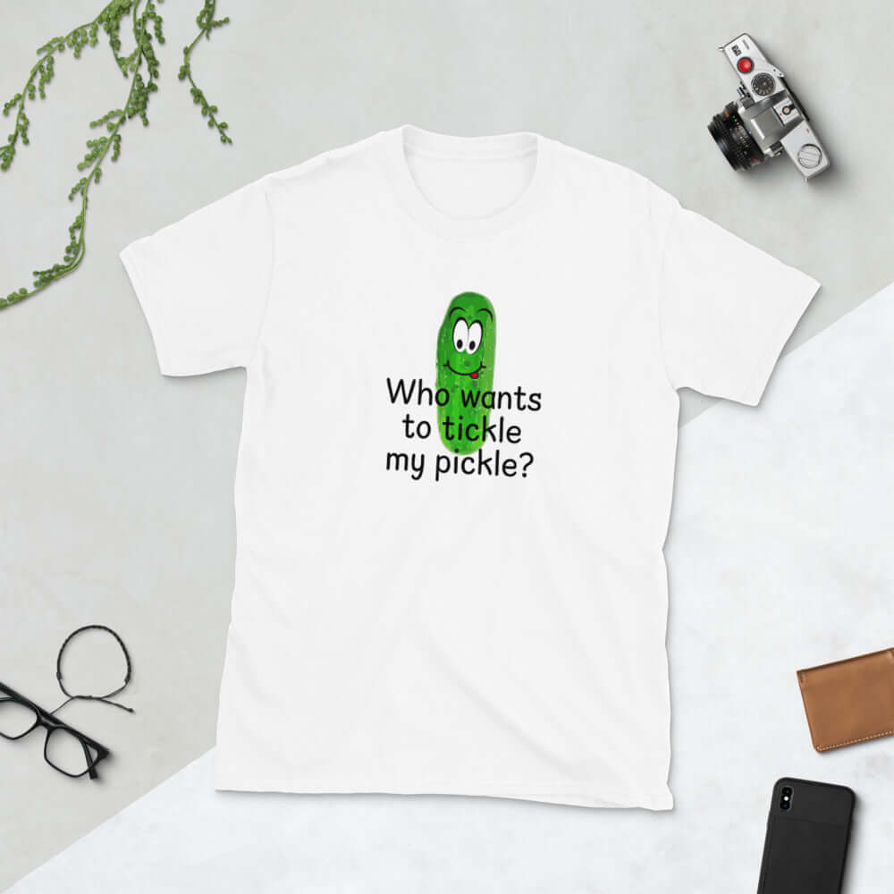 White t-shirt with an image of a pickle printed on the front. The words Who wants to tickle my pickle are printed under the pickle.