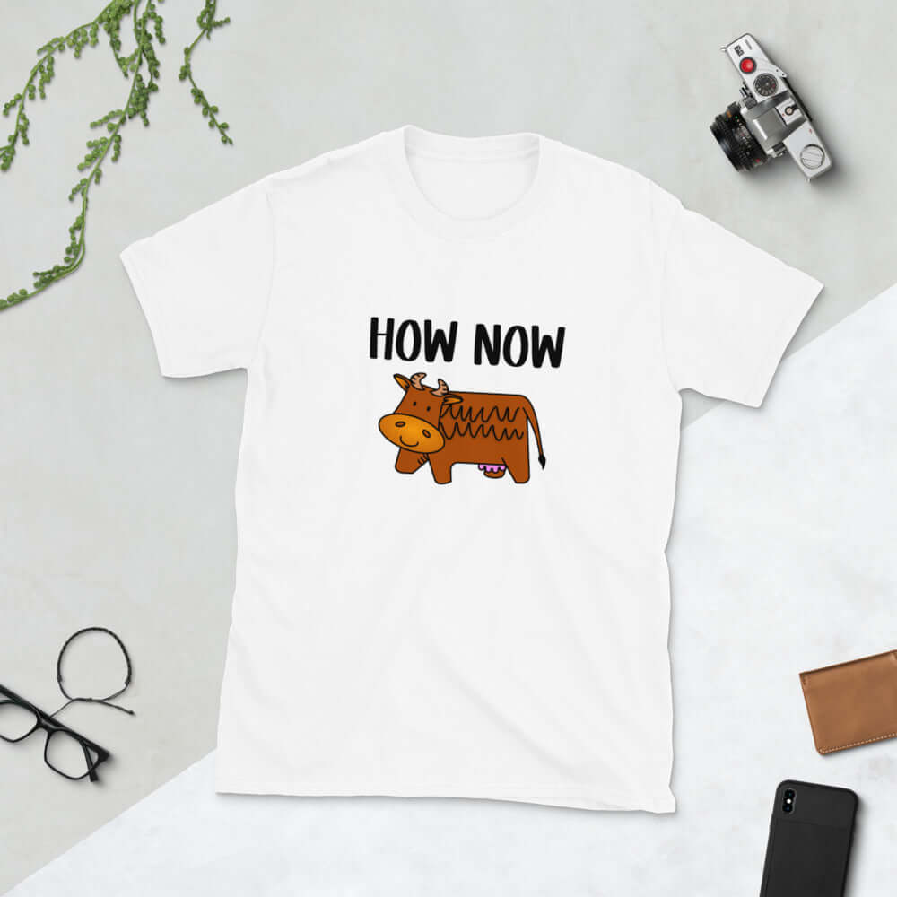 White t-shirt with the words How now and an image of a brown cow printed on the front.