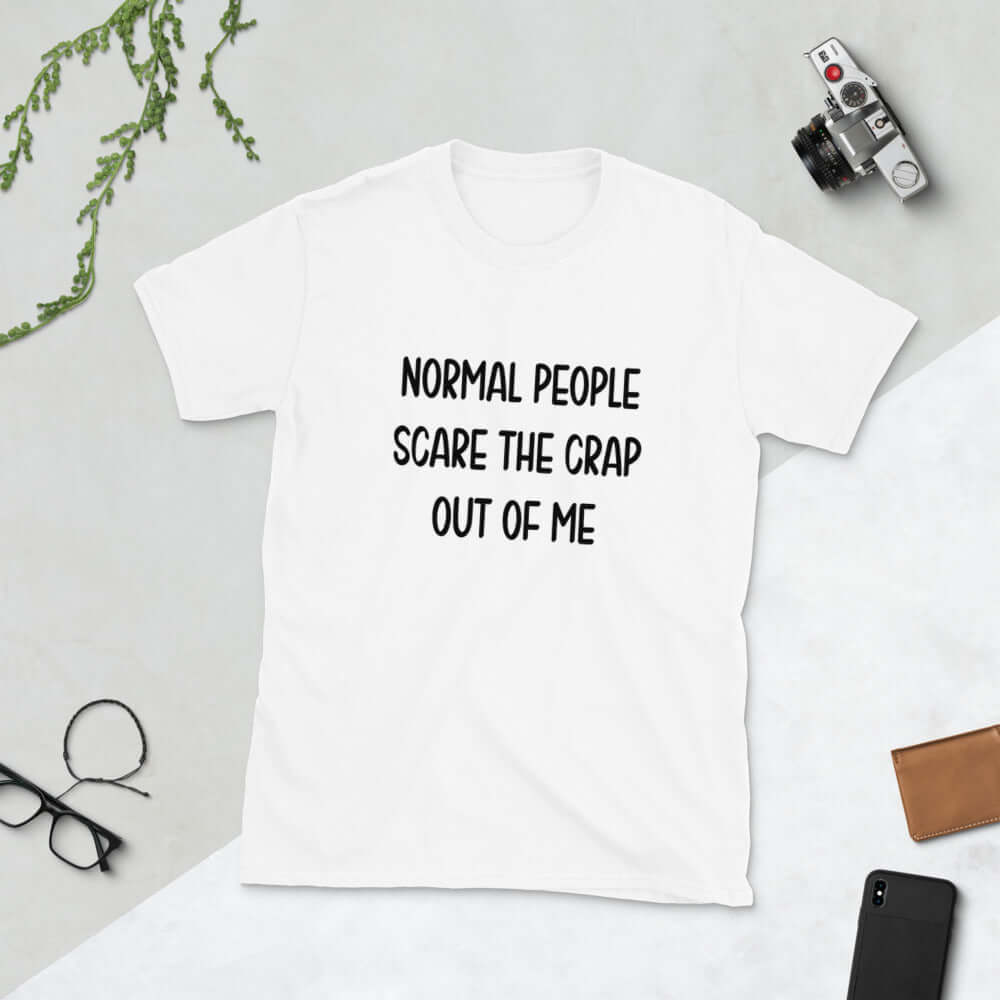 White t-shirt with the phrase Normal people scare the crap out of me printed on the front.