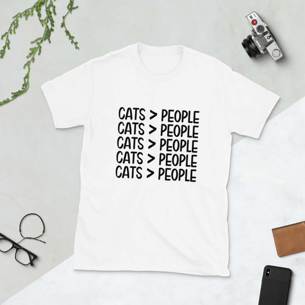 White t-shirt with the words Cats > people printed on the front.