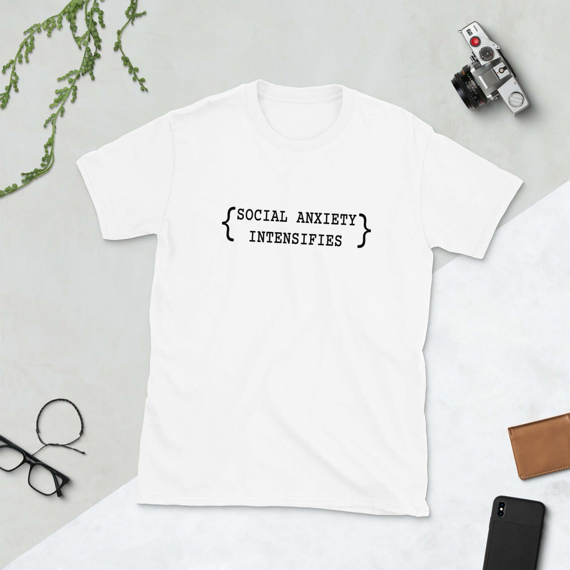 White t-shirt with the words Social anxiety intensifies printed on the front.