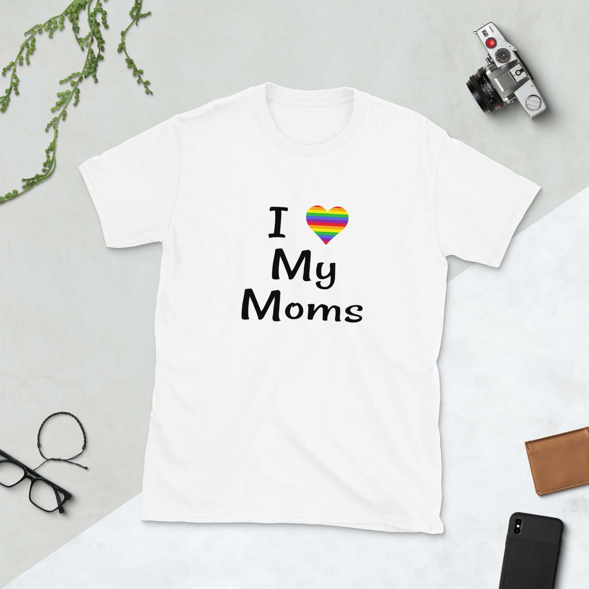 White t-shirt with I heart my moms printed on the front. The heart is rainbow colors.