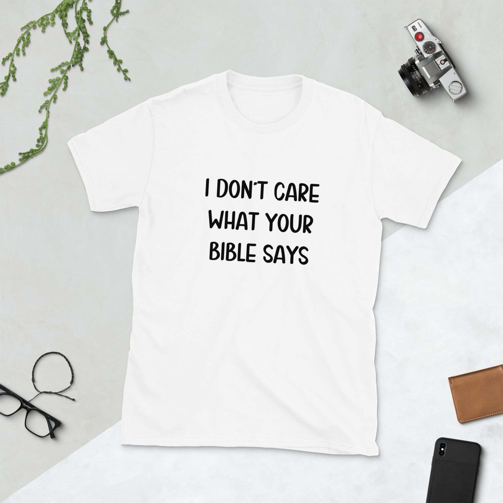 White t-shirt with the words I don't care what your bible says printed on the front.