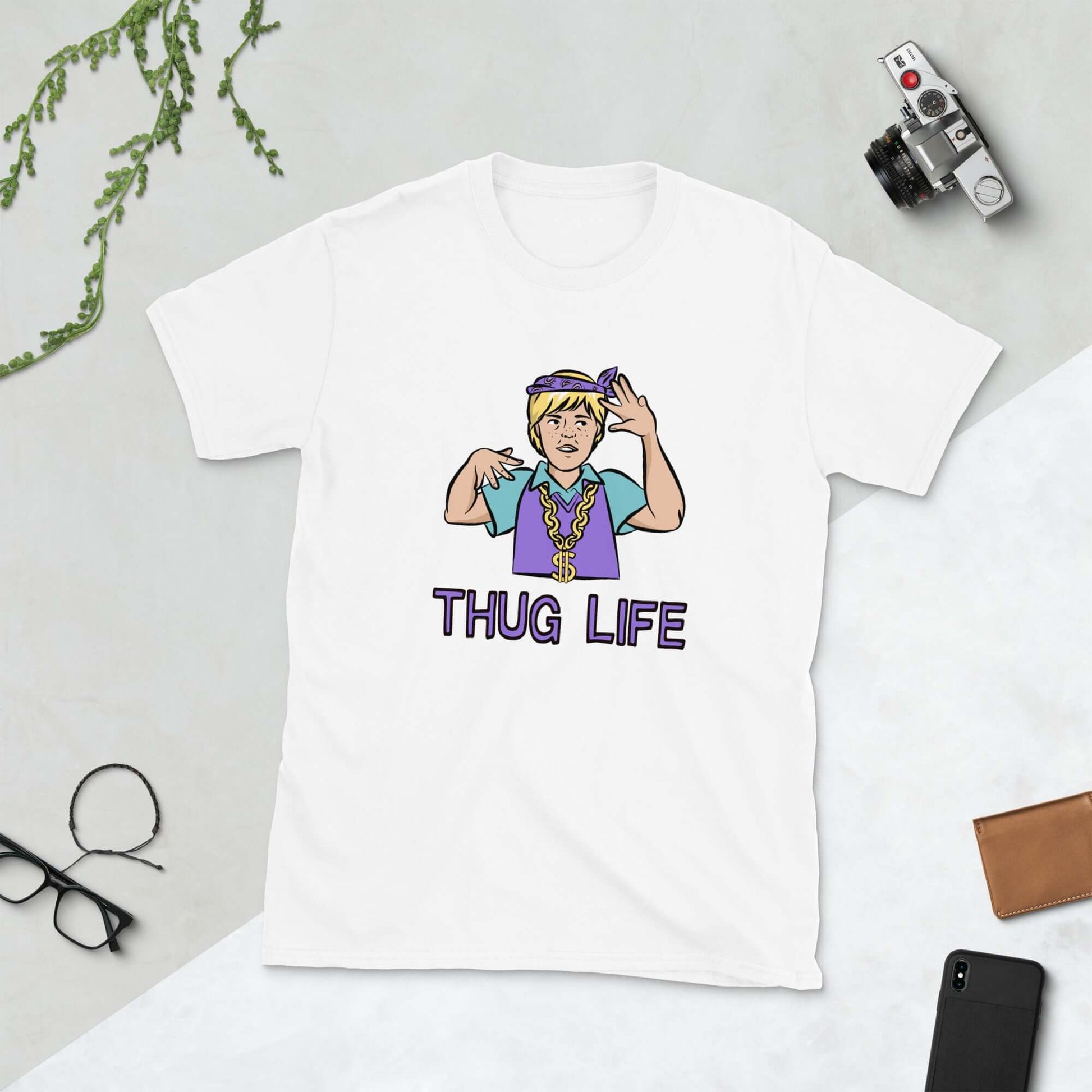 White t-shirt with a parody image of a blond haired child trying to be a gangster with the words Thug Life printed on the front.