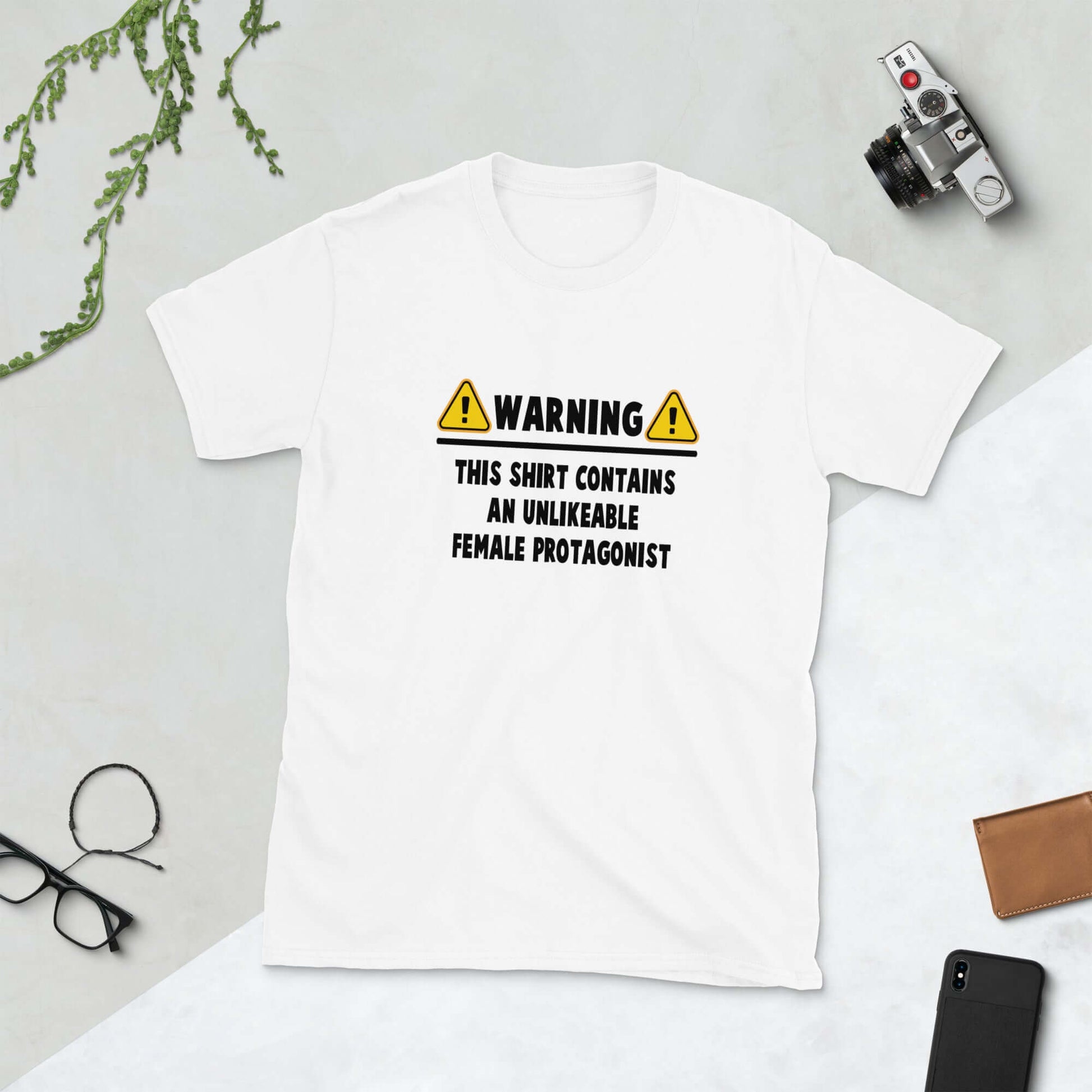 White t-shirt with the words Warning this hoodie contains an unlikable female protagonist printed on the front.